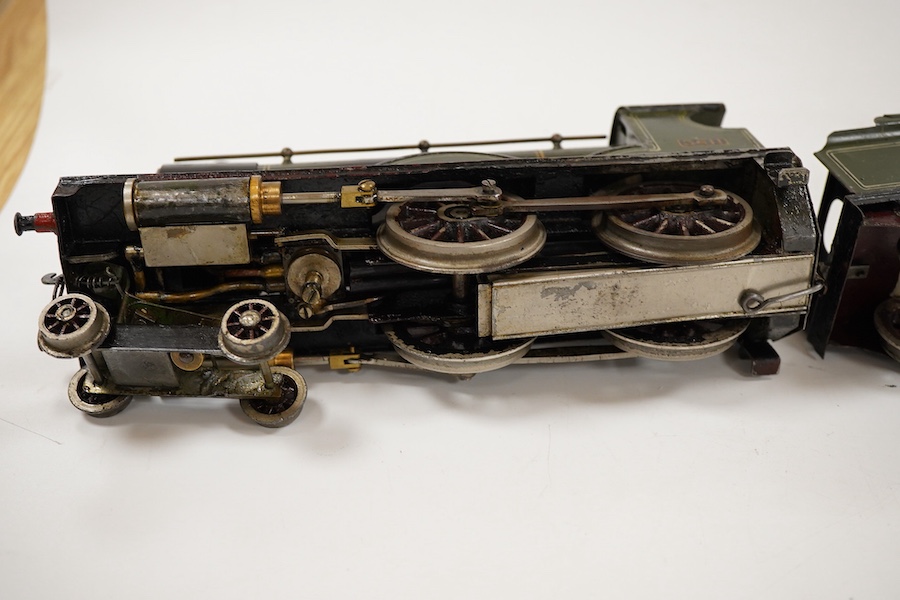 An 0 gauge live steam spirit fired tinplate GWR 4-4-0 tender locomotive, possibly Bing for Bassett-Lowke, 3411, with original fuel tank and burner, two controls in the cab and four wheel tender